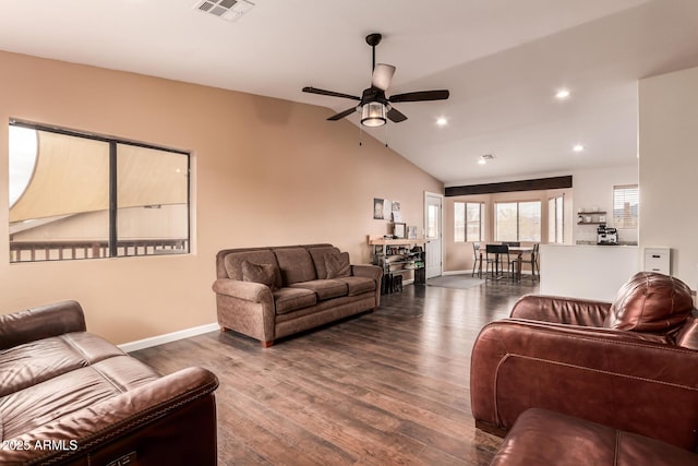 living area with lofted ceiling, wood finished floors, visible vents, and baseboards