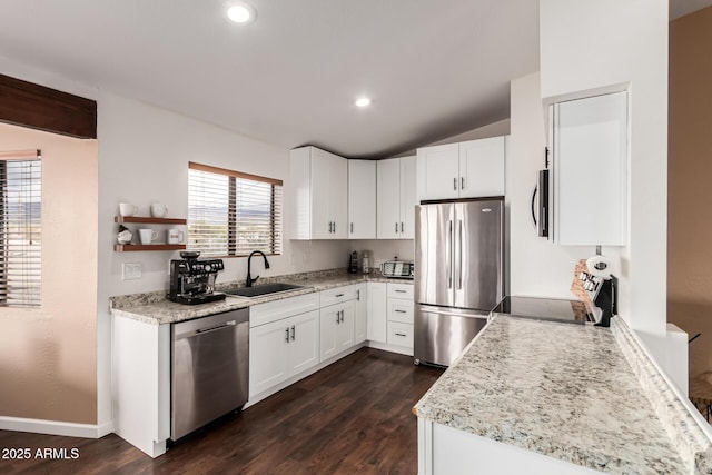 kitchen with dark wood finished floors, white cabinets, stainless steel appliances, and a sink