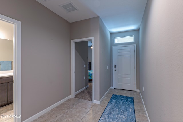 doorway to outside featuring light tile patterned flooring