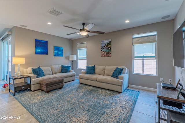 living room featuring ceiling fan, plenty of natural light, and light tile patterned floors