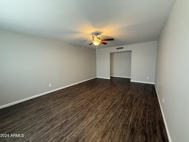 unfurnished room with dark hardwood / wood-style flooring and ceiling fan