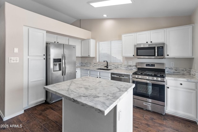 9231 W Grovers Ave, Peoria, AZ 85382 - kitchen featuring appliances with stainless steel finishes, lofted ceiling, a sink, dark wood finished floors, and white cabinets