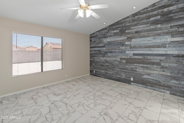 9231 W Grovers Ave, Peoria, AZ 85382 - unfurnished room with vaulted ceiling, wooden walls, a ceiling fan, baseboards, and marble finish flooring