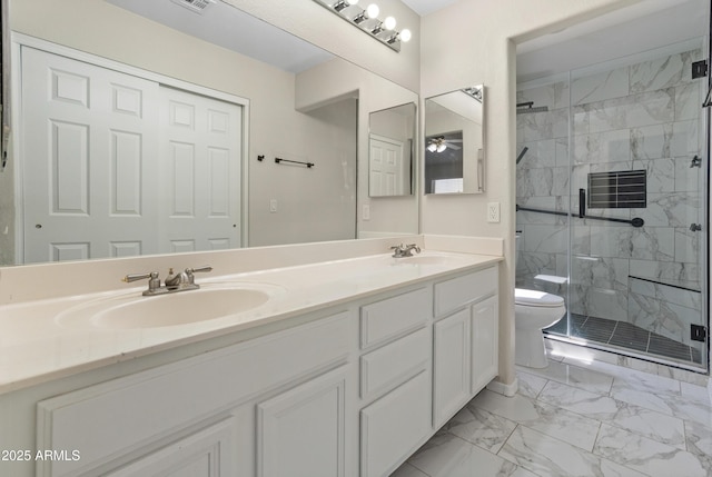 9231 W Grovers Ave, Peoria, AZ 85382 - bathroom featuring toilet, double vanity, marble look tiles, a marble finish shower, and ceiling fan