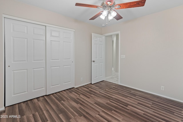 9231 W Grovers Ave, Peoria, AZ 85382 - unfurnished bedroom with dark wood-style floors, baseboards, a closet, and ceiling fan