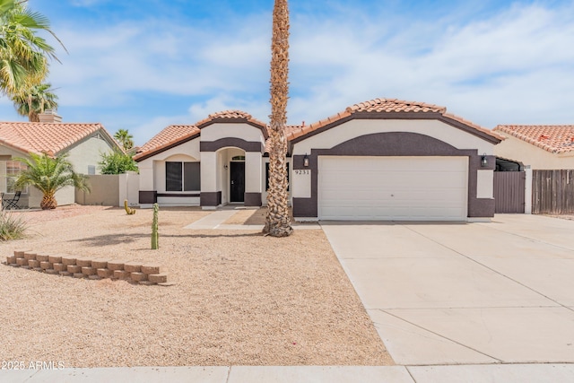 9231 W Grovers Ave, Peoria, AZ 85382 - mediterranean / spanish home with a garage, stucco siding, concrete driveway, and a tiled roof