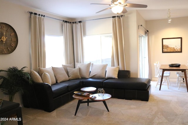 living room with a healthy amount of sunlight, ceiling fan, and light carpet