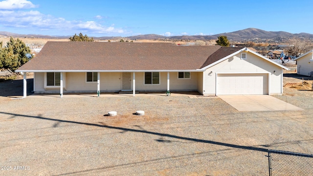 ranch-style house with a mountain view and a garage