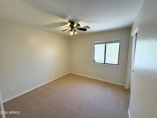 unfurnished room with ceiling fan and light colored carpet