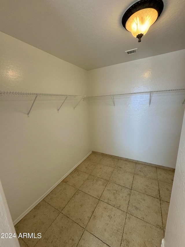 spacious closet featuring tile patterned flooring