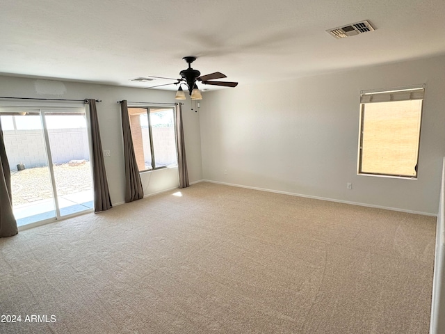 empty room with carpet floors and ceiling fan