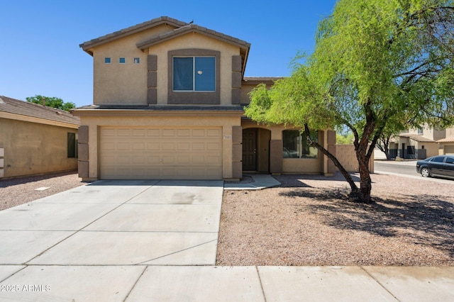 view of front facade with stucco siding, a garage, and driveway
