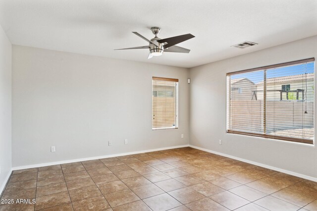 unfurnished room featuring ceiling fan, tile patterned floors, and baseboards
