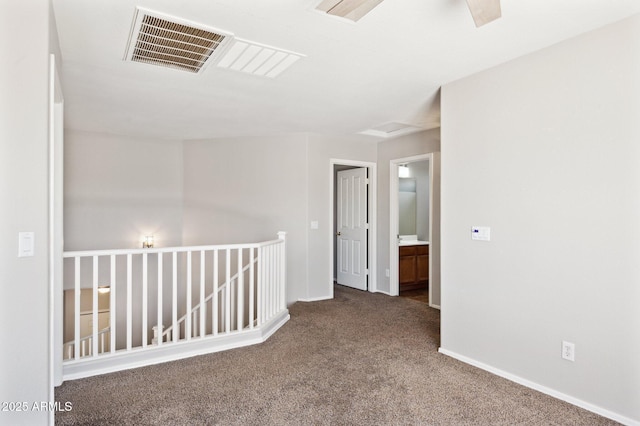carpeted empty room with baseboards