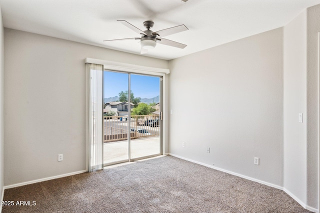 carpeted empty room with ceiling fan and baseboards