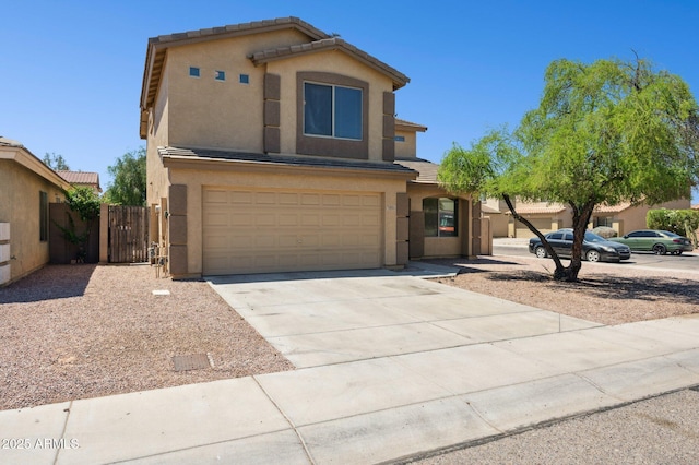 view of front of property with stucco siding, a garage, driveway, and fence