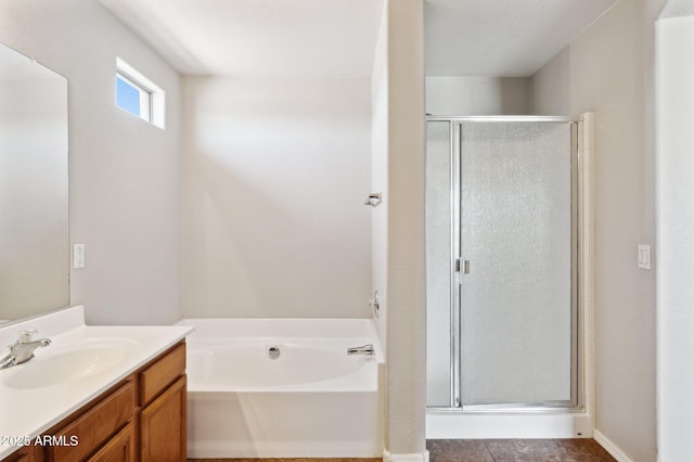 bathroom featuring a shower stall, vanity, a garden tub, and tile patterned flooring