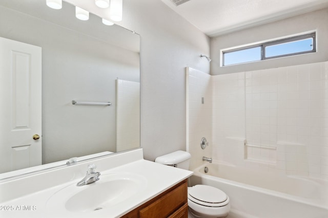 bathroom featuring toilet, vanity, and bathtub / shower combination
