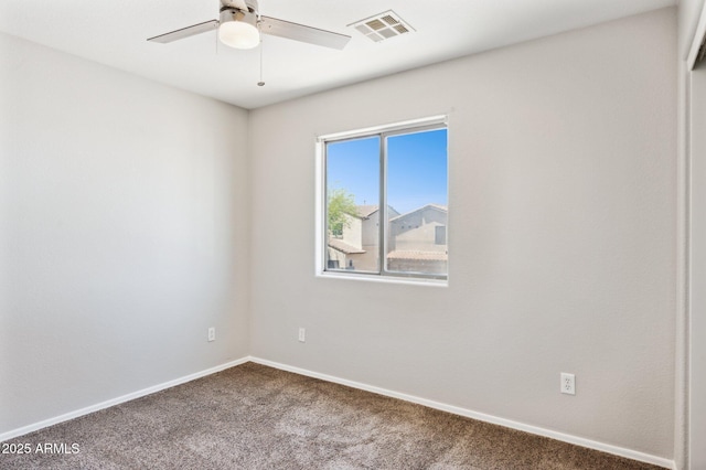 spare room with carpet flooring, a ceiling fan, and baseboards