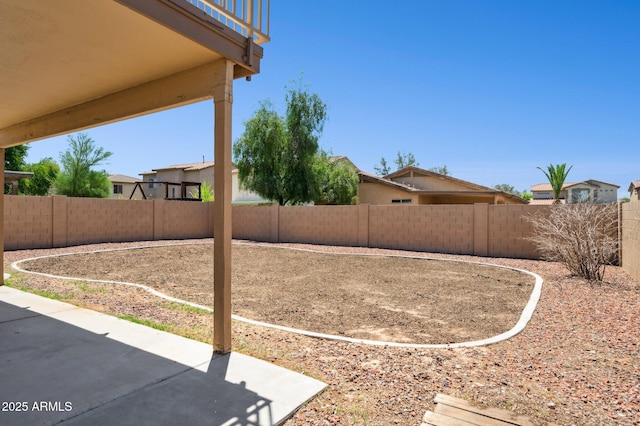 fenced backyard with a patio