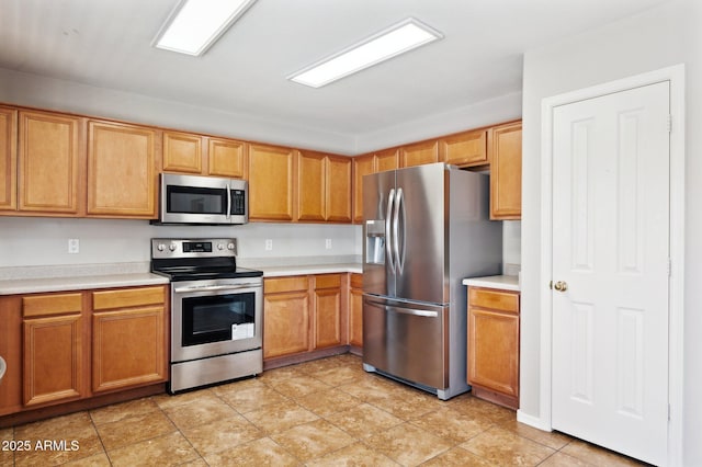 kitchen with appliances with stainless steel finishes and light countertops