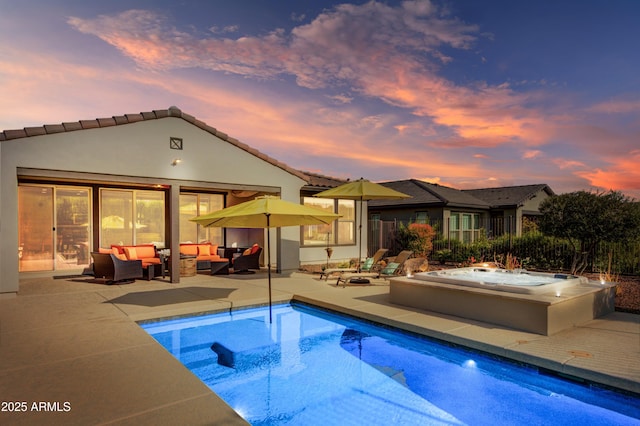 pool at dusk with an outdoor hangout area, a hot tub, and a patio