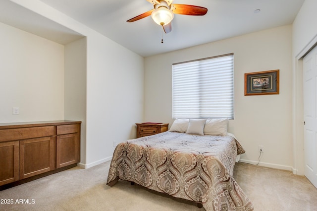 carpeted bedroom with ceiling fan and a closet