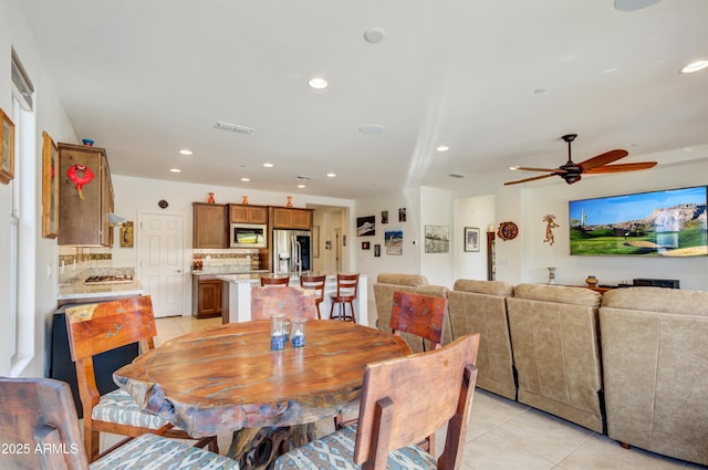 tiled dining room featuring ceiling fan