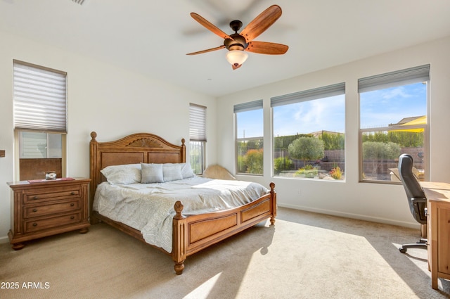 bedroom featuring light carpet and ceiling fan