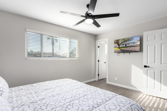 bedroom with ceiling fan and dark hardwood / wood-style floors