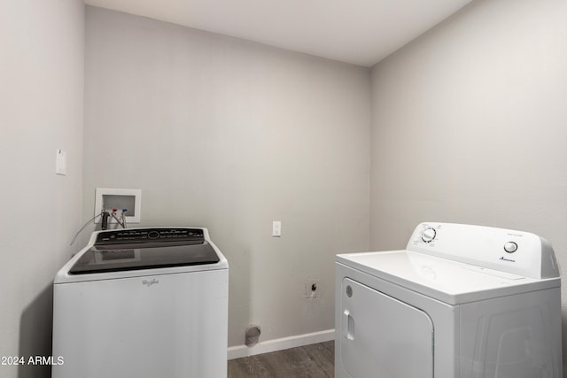 clothes washing area featuring separate washer and dryer and dark hardwood / wood-style floors