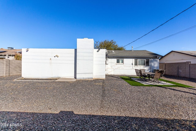 back of property with a patio