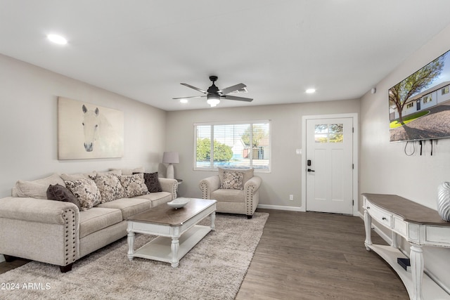 living room featuring hardwood / wood-style floors and ceiling fan