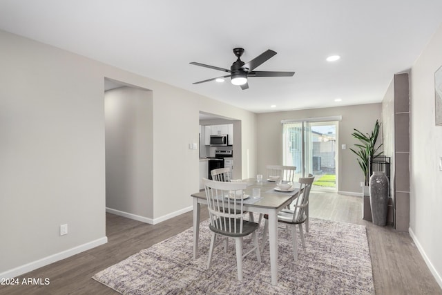 dining area with hardwood / wood-style floors and ceiling fan