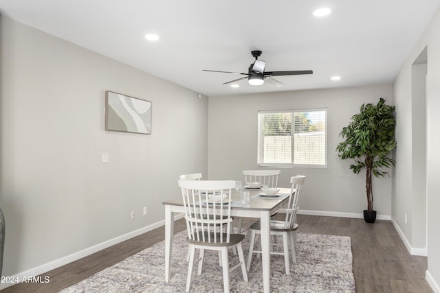 dining room with dark hardwood / wood-style flooring and ceiling fan