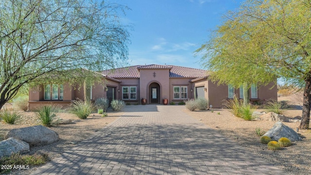 mediterranean / spanish house with a garage