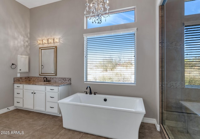 bathroom featuring separate shower and tub, tile patterned flooring, vanity, and a chandelier