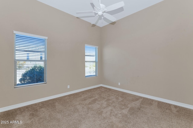 empty room featuring light carpet, a wealth of natural light, and ceiling fan