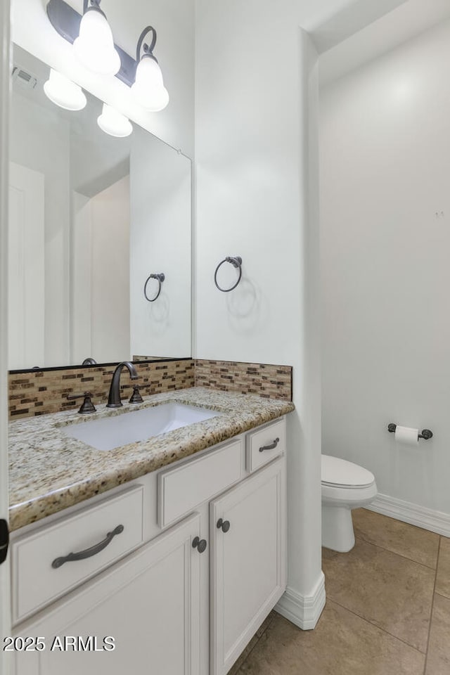 bathroom with tile patterned floors, decorative backsplash, toilet, and vanity