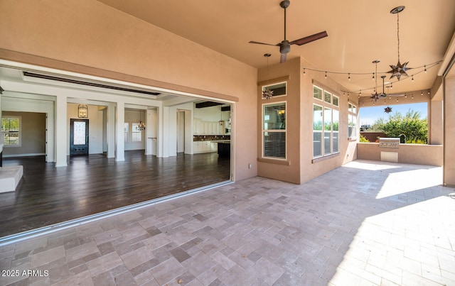 view of patio featuring area for grilling and ceiling fan