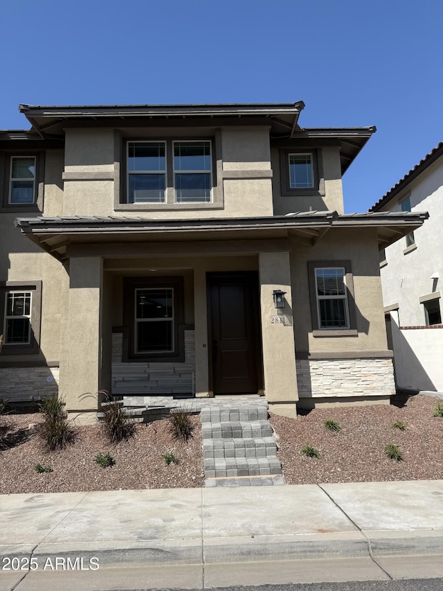 2811 N Claire Dr, Buckeye, AZ 85396 - prairie-style home with stucco siding, a porch, and stone siding