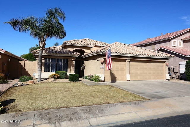 mediterranean / spanish-style home featuring a garage