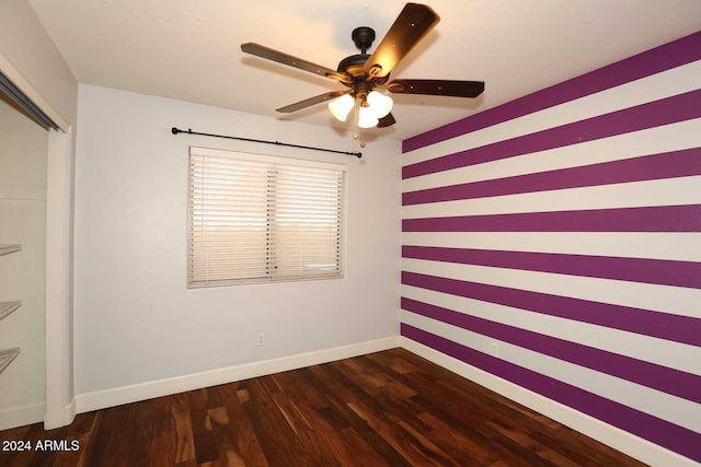 empty room featuring ceiling fan and dark hardwood / wood-style floors