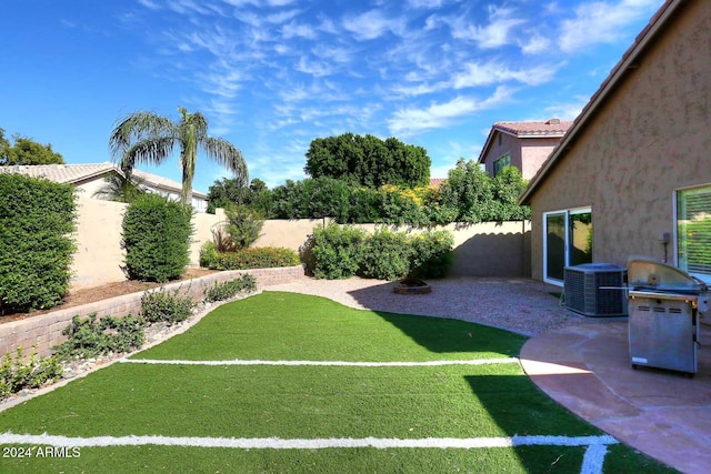 view of yard with a patio and central air condition unit