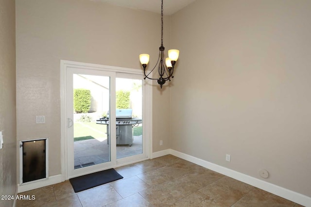 doorway to outside with a high ceiling and an inviting chandelier