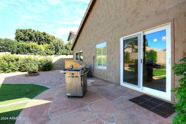 view of patio / terrace featuring a grill and an outdoor fire pit