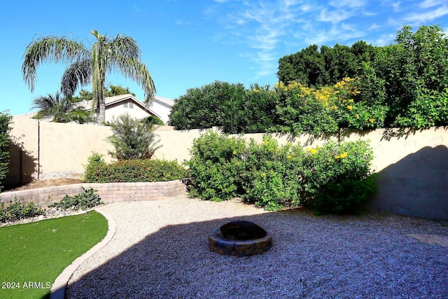 view of yard with a fire pit