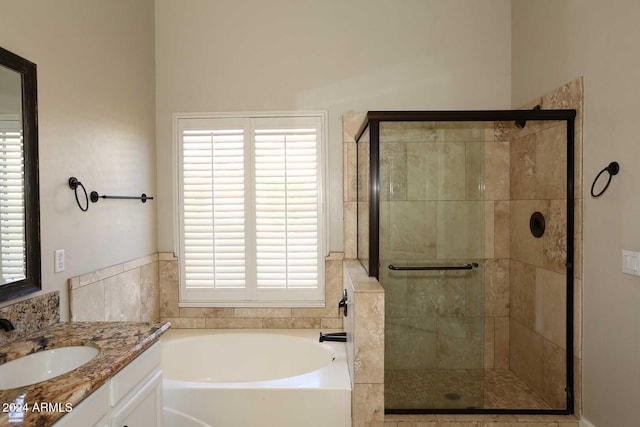 bathroom with vanity and separate shower and tub