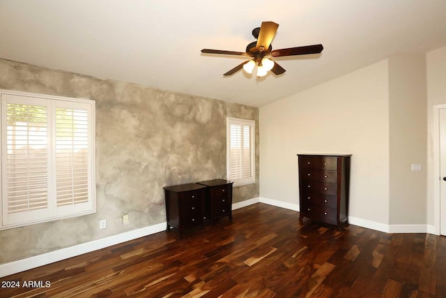 empty room with ceiling fan and dark hardwood / wood-style flooring