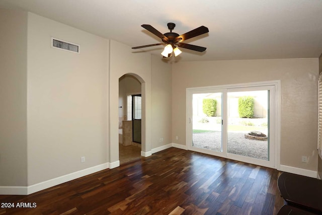 spare room with lofted ceiling, ceiling fan, and dark wood-type flooring